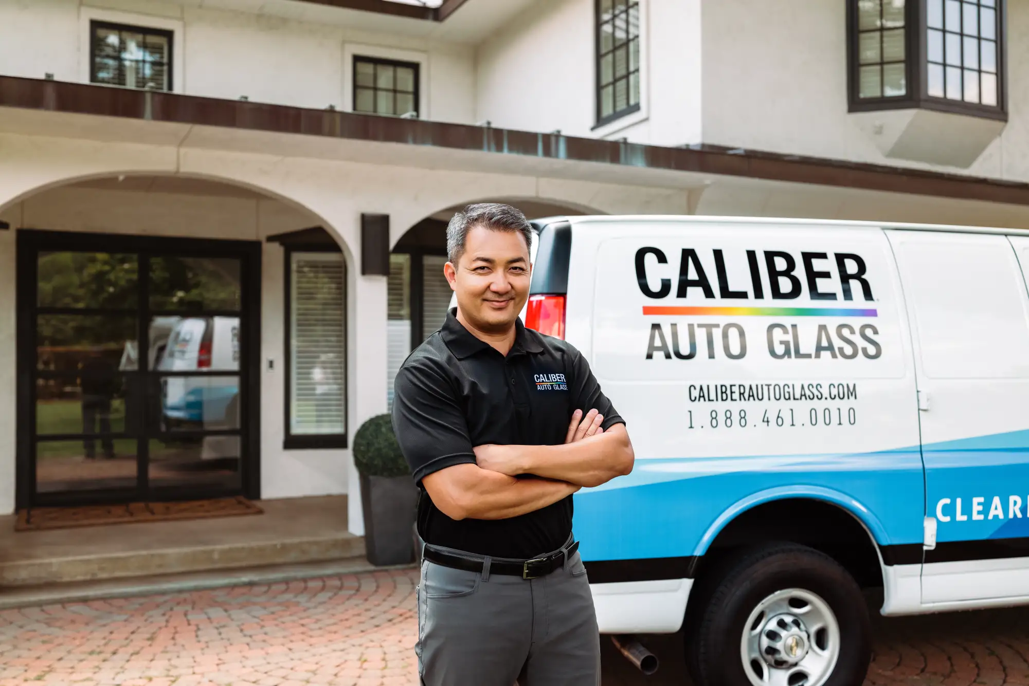 Caliber Auto Glass Mobile Repair Tech ready to replace a windshield at customer's home.